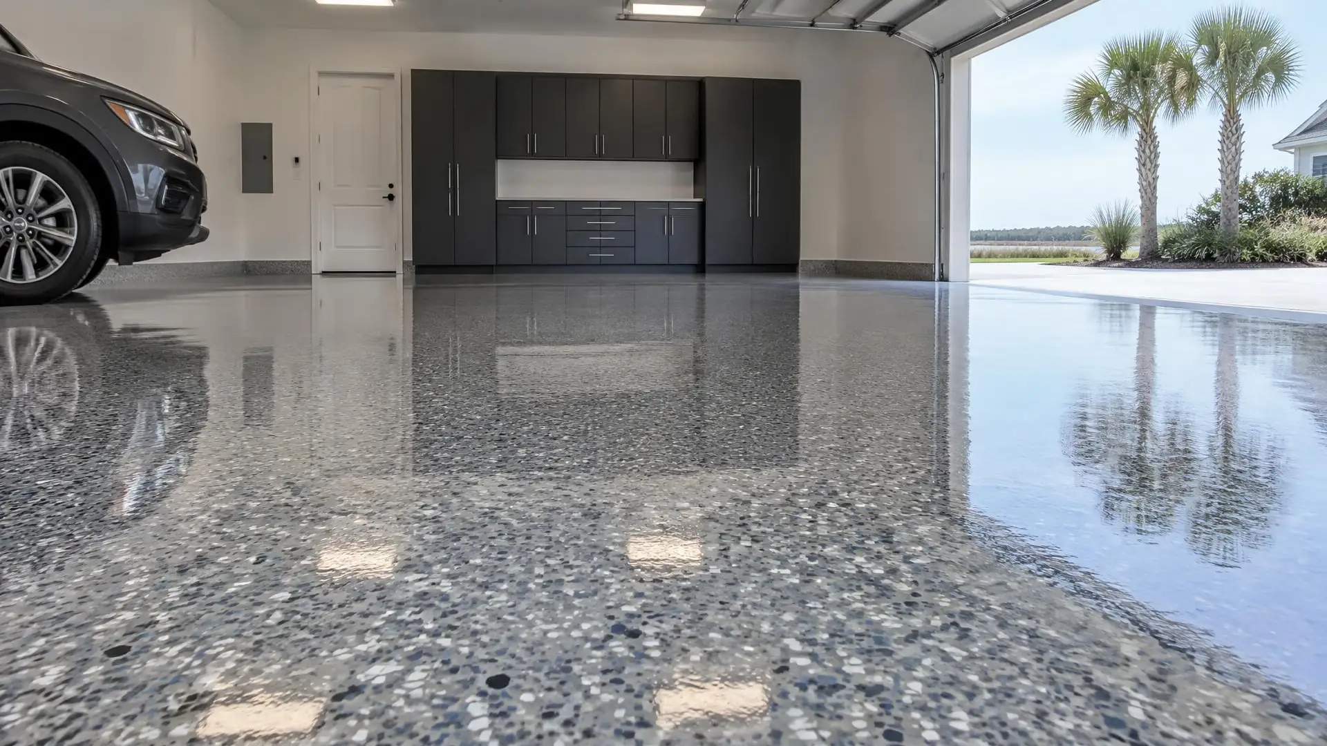 Epoxy flooring in a Myrtle Beach, SC garage: high-gloss gray flake floor with a car parked at the side