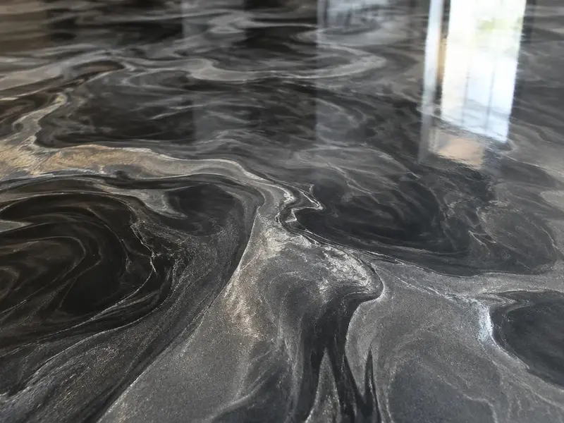 Close-up of a swirled charcoal and silver metallic epoxy floor in Myrtle Beach, SC