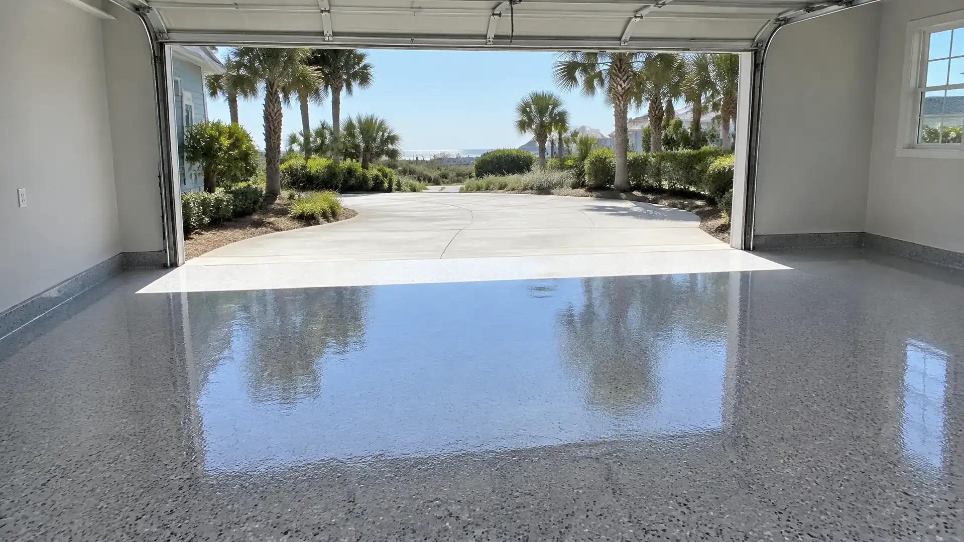 Polyaspartic floor coating in Myrtle Beach, SC: glossy gray flake garage floor in afternoon sun